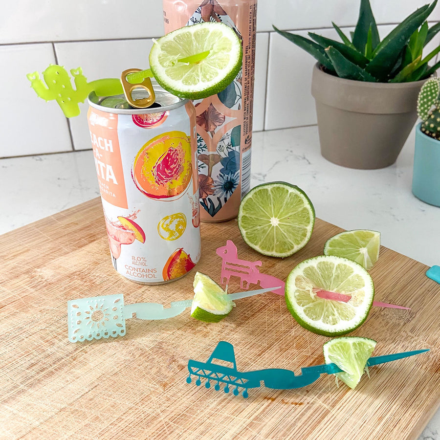 Drink markers made to fit on cans in fiesta themed shapes including a cactus, sombrero, Mexican bunting flag and a piñata. Swizzly Sticks for cans.