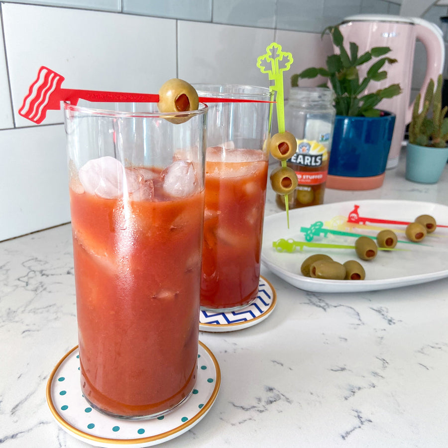 Bloody Mary cocktail pick set of Swizzly Sticks with shapes including bacon, celery, olives, pickles, hot sauce, and a lemon wedge.